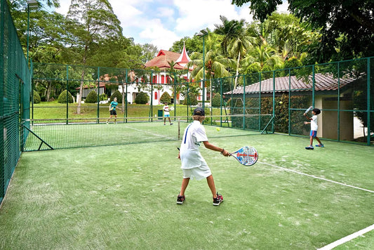 Kids playing padel at tropical court