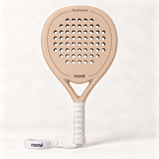Sahara beige padel racket by moné, front view: teardrop head, Play Beautifully lettering, white grip and wrist strap