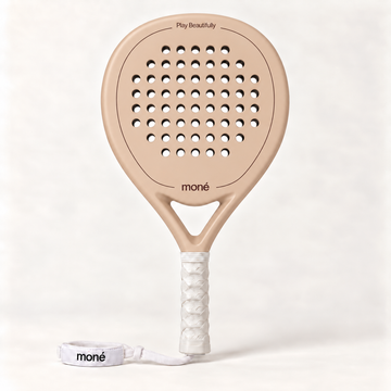 Sahara beige padel racket by moné, front view: teardrop head, Play Beautifully lettering, white grip and wrist strap