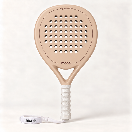 Sahara beige padel racket by moné, front view: teardrop head, Play Beautifully lettering, white grip and wrist strap