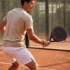Male player on court hitting a shot with the high-performance 12K carbon Moné Padel Cocoa racket.