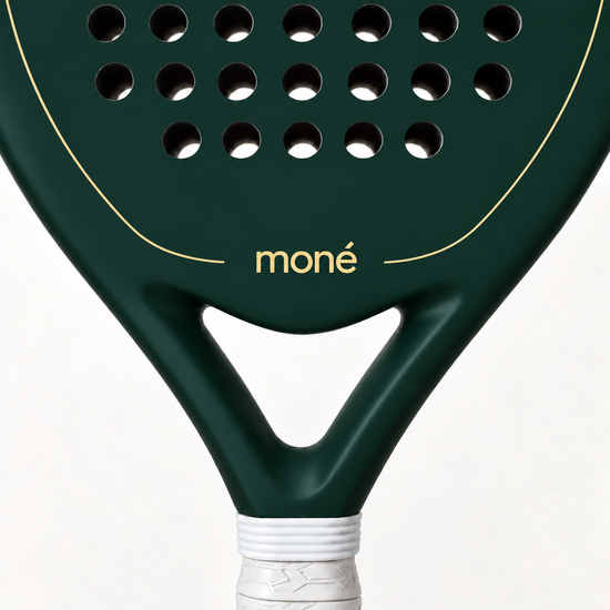 Close-up of the Forest dark green padel racket throat, with the gold moné logo and outline above its open triangle