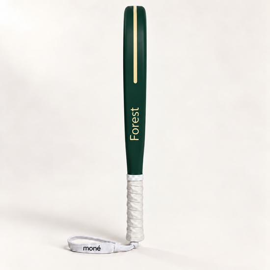 Forest dark green padel racket in side profile, with Forest printed in gold along the frame, a white grip and wrist strap