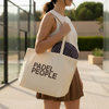 Woman holding a 'PADEL PEOPLE' tote bag outdoors