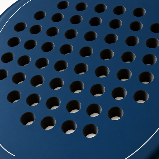 Macro of the Sailor blue padel racket face, showing its matte finish, drilled hole pattern and thin white outline