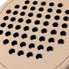 Macro of the Sahara beige padel racket face, showing its matte finish, drilled hole pattern and thin cocoa brown outline