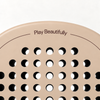 Play Beautifully printed in cocoa brown at the top of the Sahara beige padel racket, above its drilled hole pattern