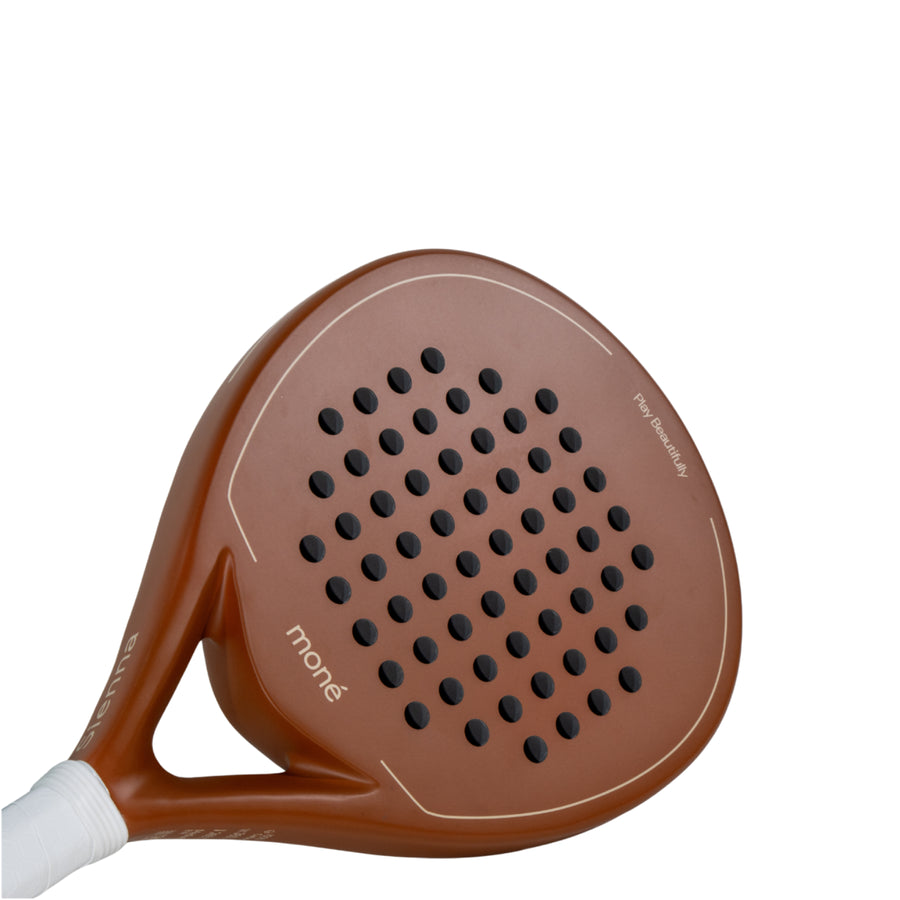 Detailed surface view of the Moné Padel Sienna premium racket showing its teardrop hole pattern and matte finish.