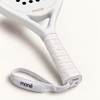 Textured white grip, logo end cap and wrist strap shown up close on the off-white Ivory Hybrid padel racket