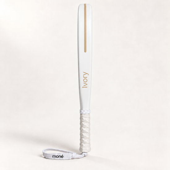 Side profile of the off-white Ivory Hybrid padel racket, its name and a stripe printed in gold along the frame