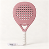 Front view of the pink Himalaya Hybrid padel racket by moné, with a white grip and wrist strap on a cream backdrop