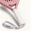 Close-up of the white textured grip, logo end cap and wrist strap on the pink Himalaya Hybrid padel racket