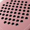 Macro of the rough textured face and drilled hole pattern on the pink Himalaya Hybrid padel racket