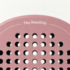 Top of the pink Himalaya Hybrid padel racket face, with Play Beautifully printed in white above the holes