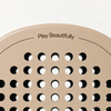 Top of the beige Sahara Hybrid padel racket face, with the Play Beautifully print above its drilled hole pattern