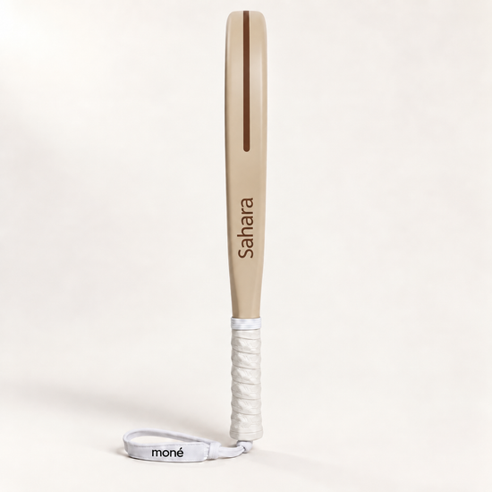Side profile of the Sahara Hybrid padel racket, a beige frame with Sahara printed in brown and a white grip