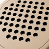 Macro view of the rough, textured beige face of the Sahara Hybrid padel racket, a finish made to help generate spin