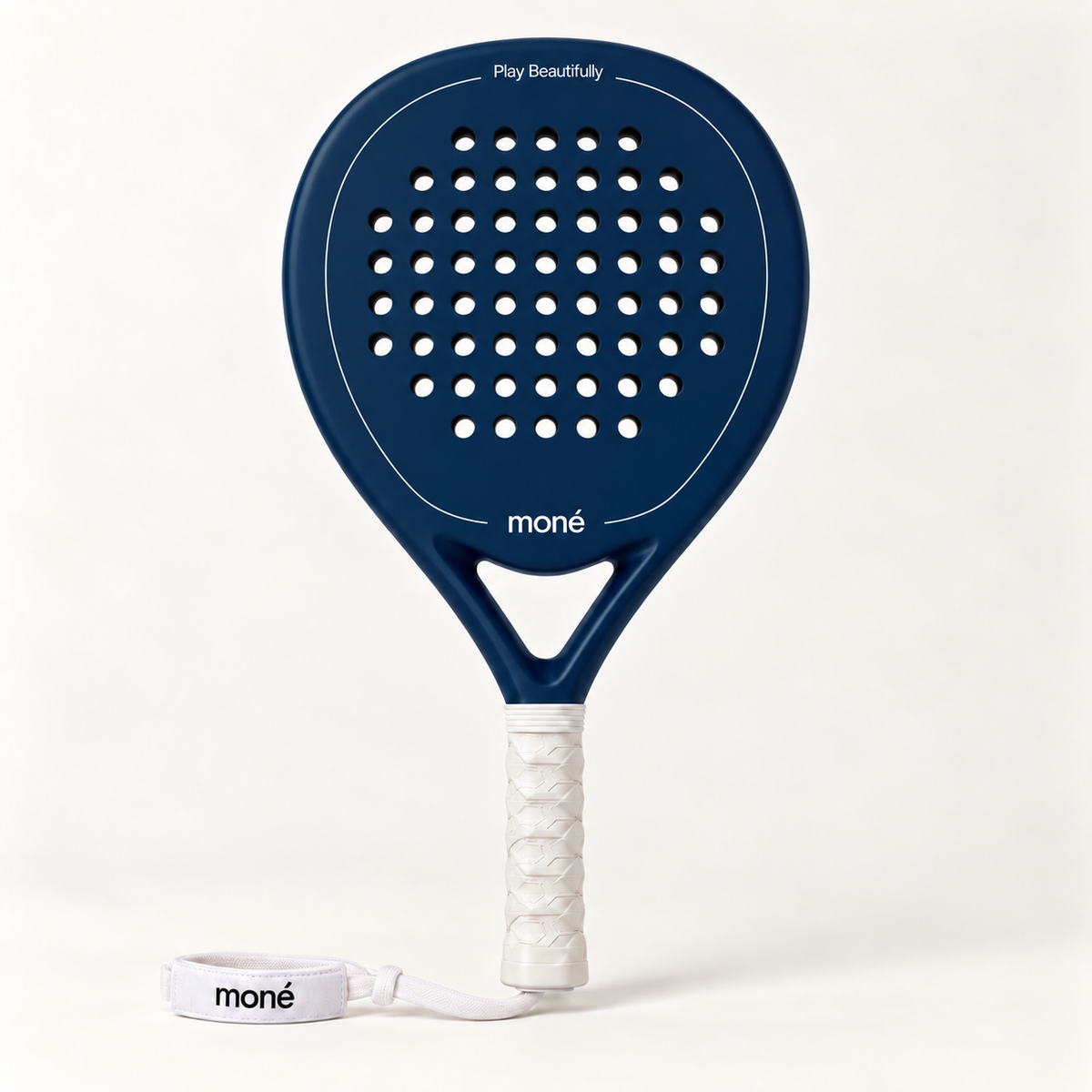 Sailor blue padel racket by moné, front view: teardrop head, Play Beautifully lettering, white grip and wrist strap